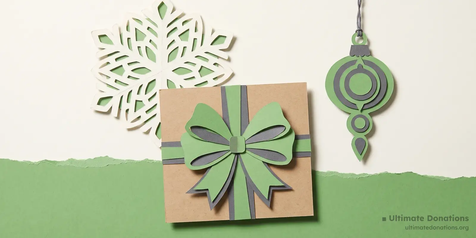 Cut-paper illustration: a wrapped gift box with a bow, a large paper snowflake, and a hanging paper ornament.